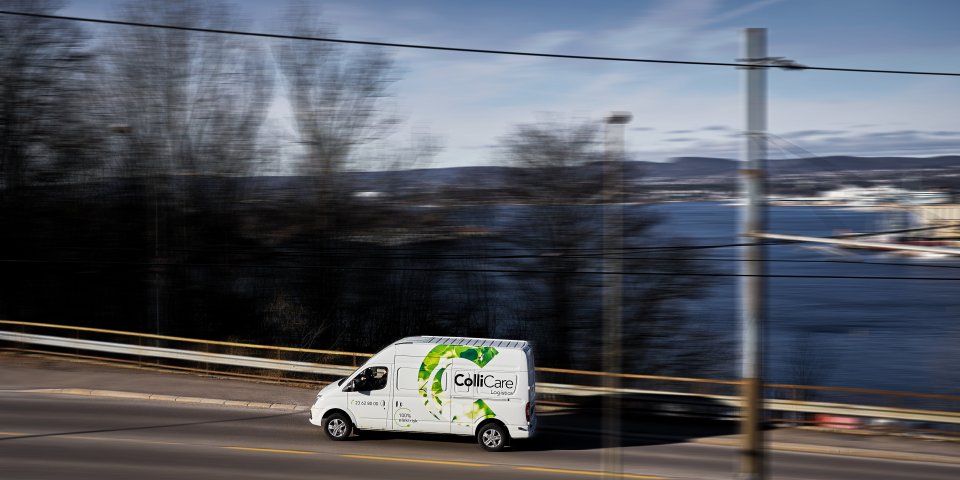 Electrical ColliCare van driving through Norwegian scenery for express delivery