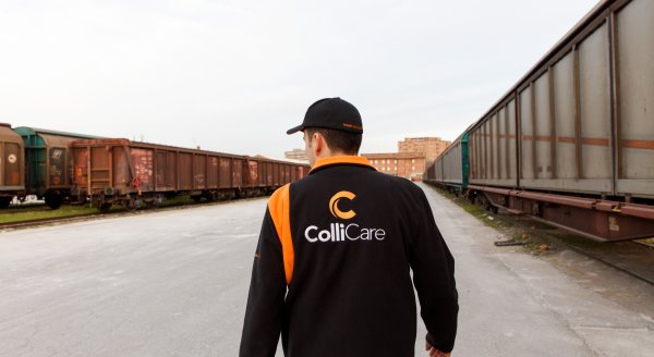 An employee in branded clothes controls the trains and logistics at a terminal located in Italy.
