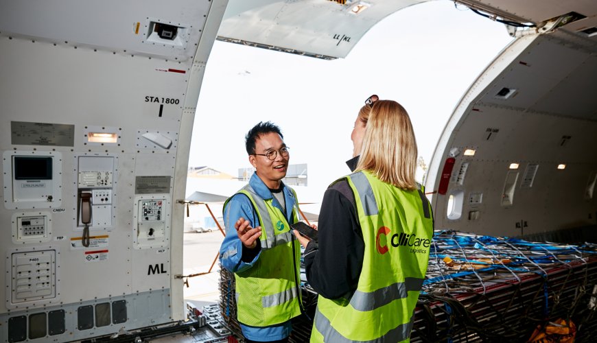 Airport-employee show ColliCare-employee the inside of a plane containing cargo and goods.