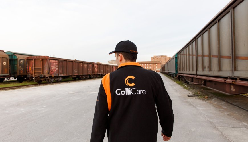 An employee in branded clothes controls the trains and logistics at a terminal located in Italy.