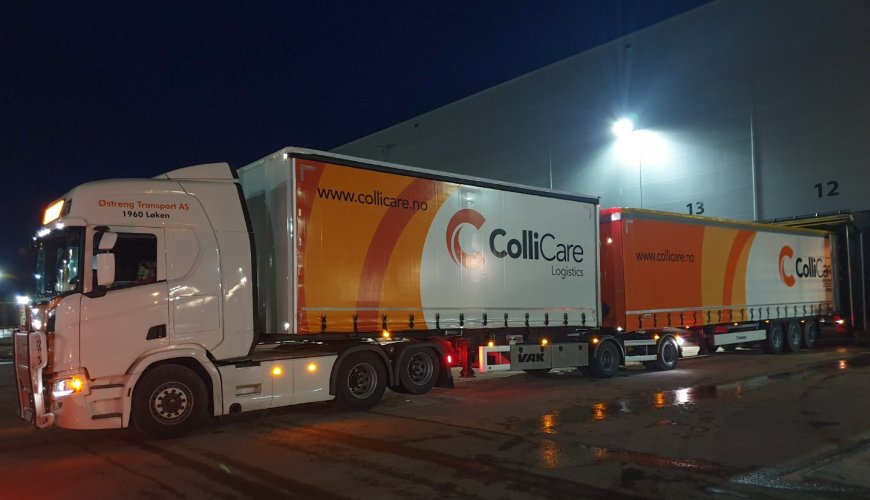 A branded ColliCare-trailer at night, parked at the terminal to unload goods.