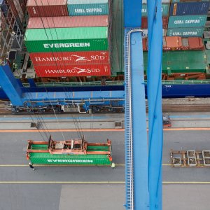 View from above of containers being loaded on to a ship in Denmark, ready to be transported by sea.
